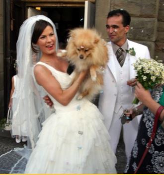 Luella Martinez's parents Roberto Martinez and Beth Thompson at their wedding with their bridesmaid Leo